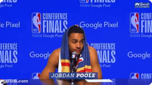 Man With Towel On Head In Front Of Google Pixel Conference Finals Sign GIF