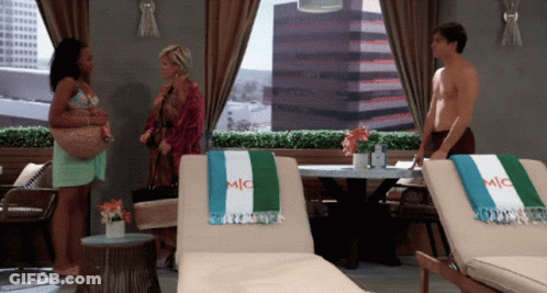 Man With Towel Saying Mic In Front Of Two Lounge Chairs GIF