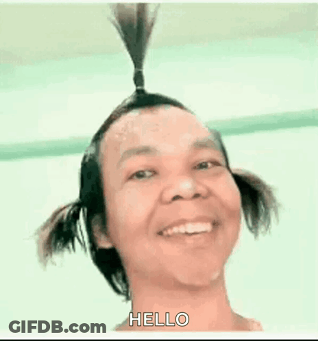 Man With Two Pigtails Smiling Saying Hello GIF