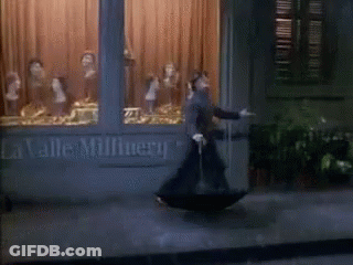 Man With Umbrella At La Valle Millnery GIF