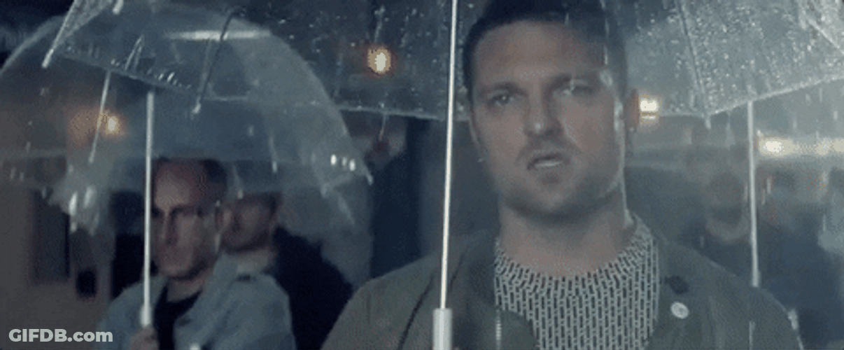 Man With Umbrella Staring Seriously GIF