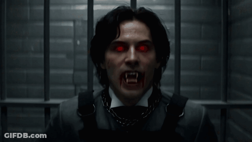 Man With Vampire Teeth And Red Eyes GIF