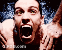 Man With Vampire Teeth And Yellow Eyes Screaming GIF
