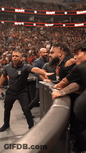Man With W Logo Shirt At Wrestling Event GIF