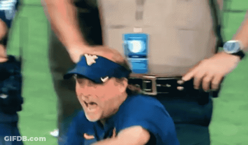 Man With W Visor Held By Police Officer GIF