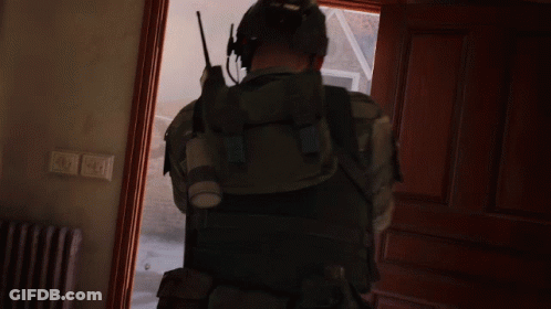 Man With Walkie Talkie Standing In Doorway GIF