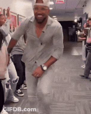 Man With Watch Dancing In Hallway With Others GIF