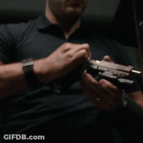 Man With Watch Holding Gun GIF