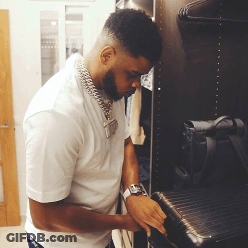Man With Watch Looks At Suitcase GIF