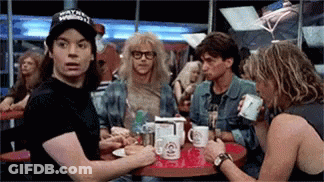 Man With Wayne Reynolds Hat At Table With Others GIF