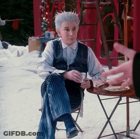 Man With White Hair Sitting At Table With Coffee GIF