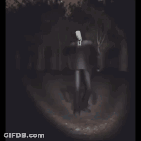 Man With White Head Standing In Dark Forest GIF