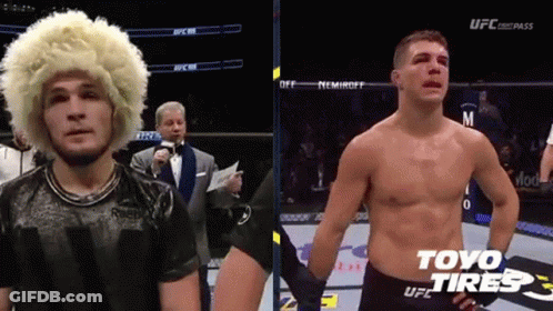 Man With Wig And Shirtless Man In Boxing Ring GIF
