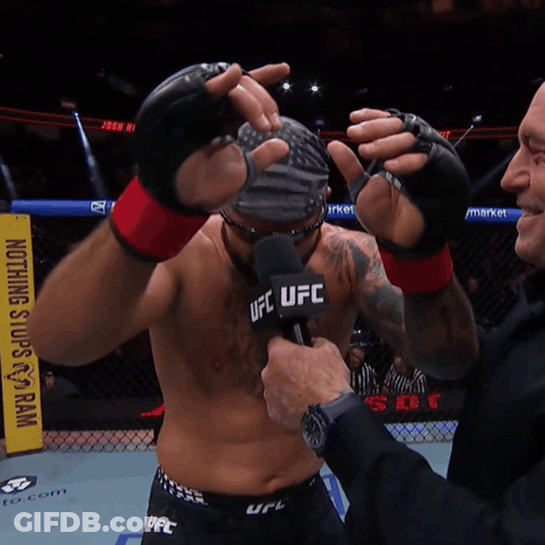 Man With Wig And Sunglasses In Front Of UFC Sign GIF