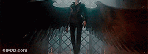 Man With Wings Standing In Dark Room With Cane GIF
