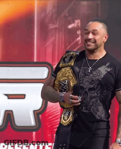 Man With Wrestling Belt And Presente Sign GIF