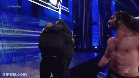 Man With Wrestling Logo On Shirt Close Up GIF