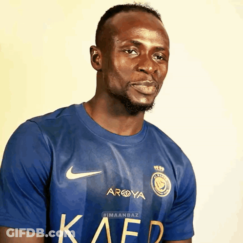 Man With Yellow Stripes On Soccer Field GIF