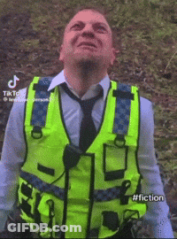 Man With Yellow Vest And Tie Looking Skyward GIF