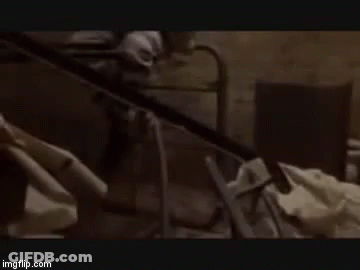 Man Without Shirt Arms Outstretched In Dark Room GIF