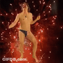 Man Without Shirt Dancing In Fireworks GIF