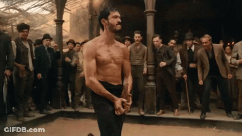 Man Without Shirt Facing Crowd Of Men GIF