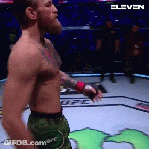 Man Without Shirt Holding Boxing Glove GIF