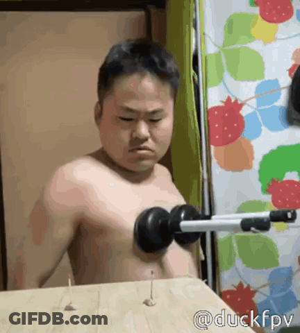 Man Without Shirt Holding Dumbbell GIF