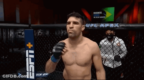 Man Without Shirt In Cage In Front Of UFC Apex Sign GIF