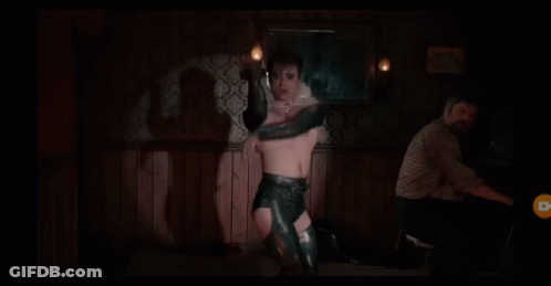 Man Without Shirt In Feathered Collar And Gloves GIF