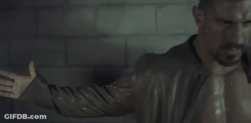 Man Without Shirt In Front Of Brick Wall GIF