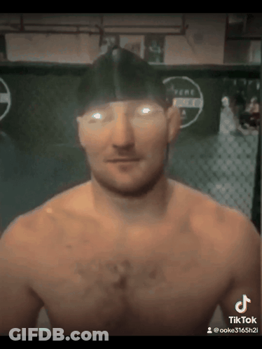 Man Without Shirt In Front Of Fence GIF