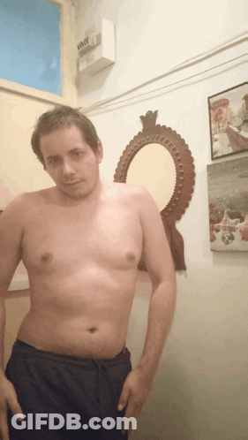 Man Without Shirt In Front Of Mirror And Eee Box GIF