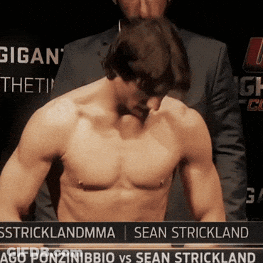 Man Without Shirt In Front Of Sstricklandmma Sign GIF