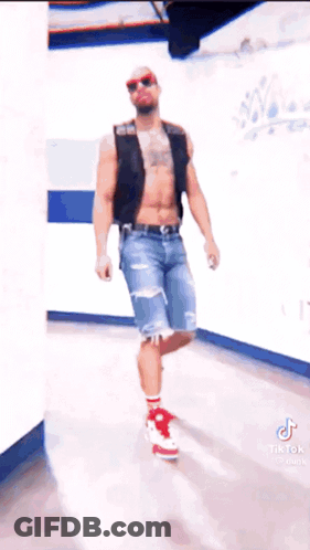 Man Without Shirt In Hallway Wearing Red Shoes And Sunglasses GIF