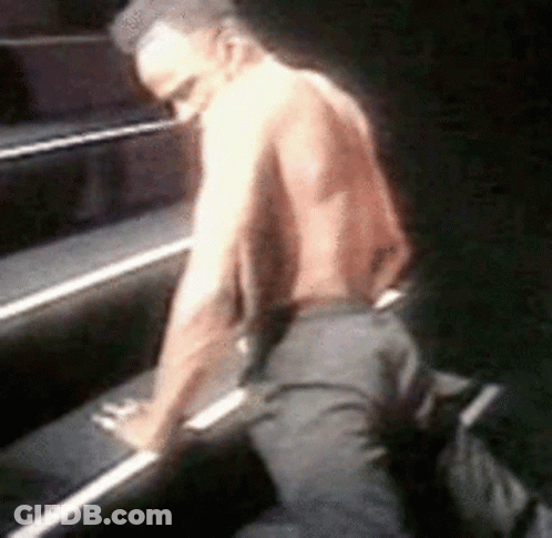 Man Without Shirt Kneeling On Piano GIF