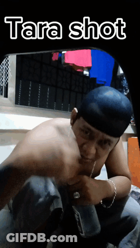 Man Without Shirt Kneeling With Tara Shot Above GIF