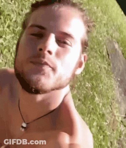 Man Without Shirt Laying In Grass GIF