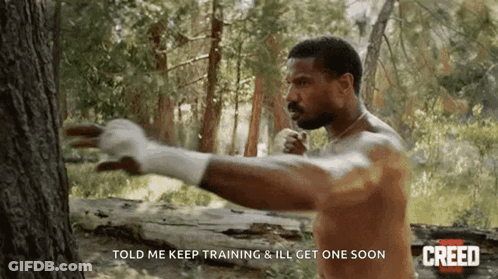 Man Without Shirt Next To Tree GIF