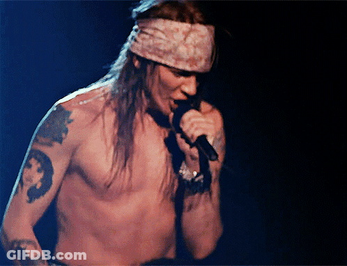 Man Without Shirt Singing Into Microphone GIF