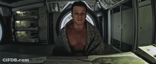 Man Without Shirt Sitting At Table GIF