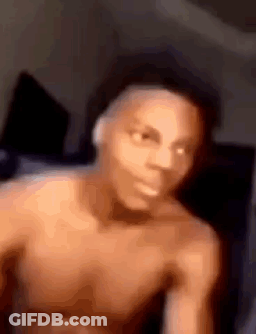Man Without Shirt Sitting On Bed GIF