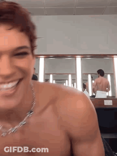 Man Without Shirt Smiling In Mirror GIF