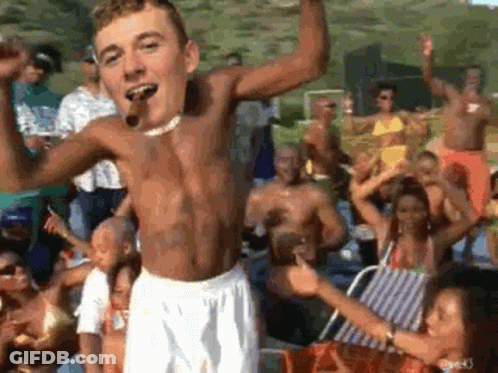 Man Without Shirt Smoking Cigar In Front Of Crowd GIF