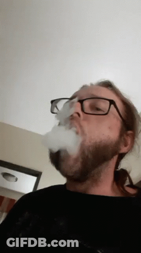 Man Without Shirt Smoking Cigarette Outdoors GIF