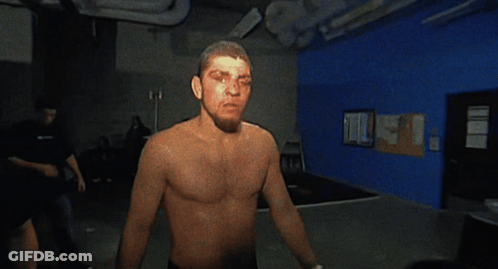 Man Without Shirt Standing In Dark Room GIF