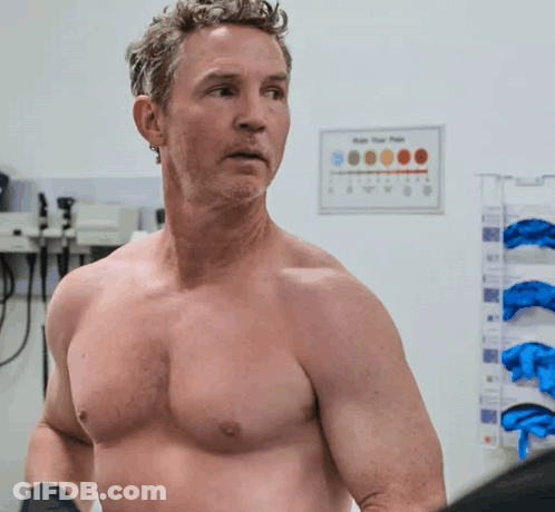 Man Without Shirt Standing In Front Of App Your Pain Sign GIF