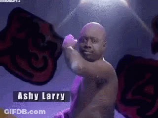 Man Without Shirt Standing In Front Of Ashy Larry Sign GIF