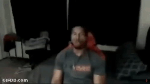 Man Without Shirt Standing Next To Tree In Park GIF