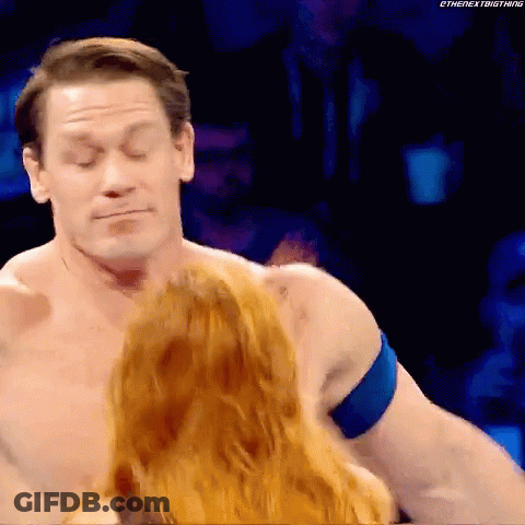 Man Without Shirt Standing Next To Woman With Red Hair GIF